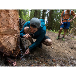 MSR TrailShot Pocket-Sized Water Filter in use in the forest