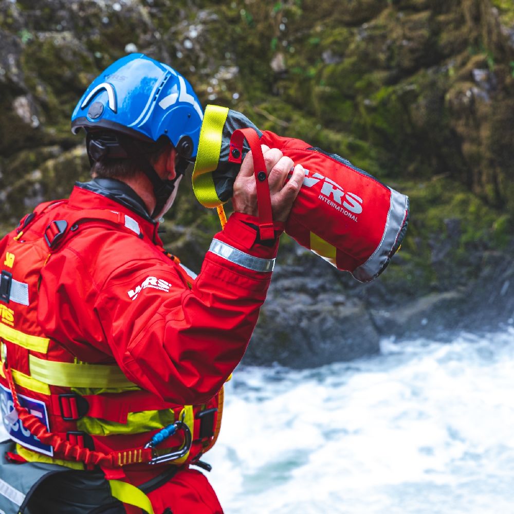 Rescue Responder about to throw WRS Chaos Thow Bag with rope into a whitewater river